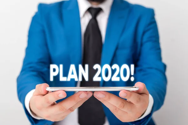Handwriting text writing Plan 2020. Concept meaning detailed proposal doing achieving something next year Businessman in blue suite with a tie holds lap top in hands. — Stock Photo, Image