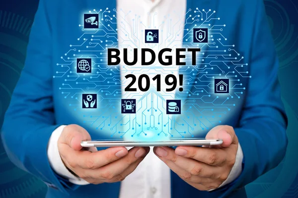 Handwriting text writing Budget 2019. Concept meaning the estimate of income and expenditure for current year Male human wear formal work suit presenting presentation using smart device. — Stock Photo, Image