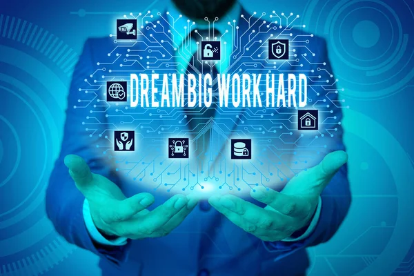 Writing note showing Dream Big Work Hard. Business photo showcasing Believe in yourself and follow the dreams and goals Male wear formal work suit presenting presentation smart device.