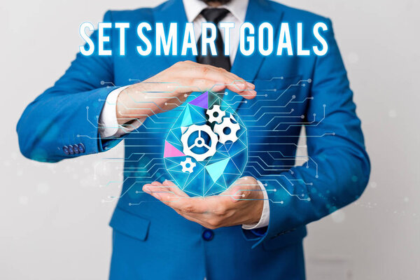 Handwriting text writing Set Smart Goals. Concept meaning giving criteria to guide in the setting of objectives Man net gears bubble hands suit machinery stuff office technological device.