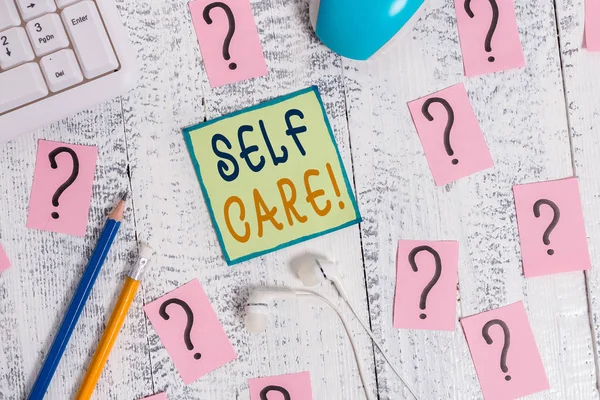 Text sign showing Self Care. Conceptual photo practice of taking action preserve or improve ones own health Writing tools, computer stuff and scribbled paper on top of wooden table. — Stock Photo, Image