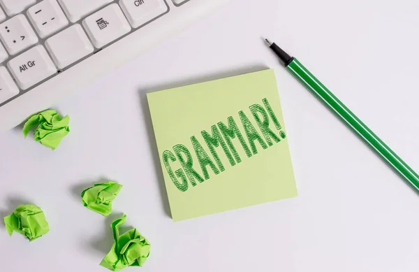 Conceptual hand writing showing Grammar. Business photo text whole system structure language syntax and morphology Green note paper with pencil on white background and pc keyboard. — Stock Photo, Image