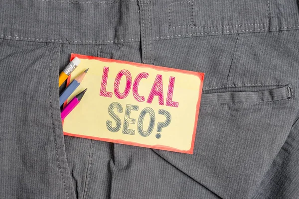 Conceptual hand writing showing Local Seoquestion. Business photo showcasing incredibly effective way to market your local business online Writing equipment and yellow notepaper in pocket of trousers.