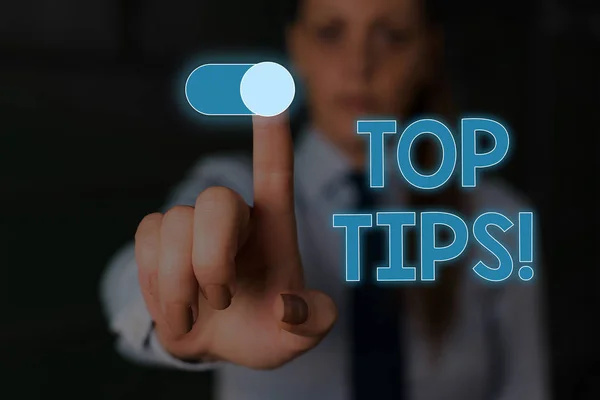 Writing note showing Top Tips. Business photo showcasing small but particularly useful piece of practical advice Woman wear formal work suit presenting presentation using smart device.