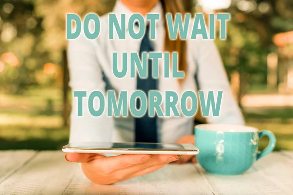 Handwriting text Do Not Wait Until Tomorrow. Concept meaning needed to do it right away Urgent Better do now Business woman sitting by the table with cup of coffee and mobile phone.