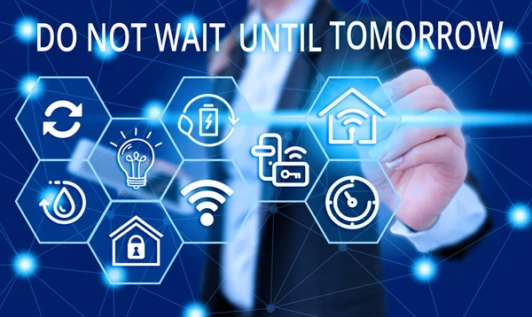 Text sign showing Do Not Wait Until Tomorrow. Conceptual photo needed to do it right away Urgent Better do now Female human wear formal work suit presenting presentation use smart device.