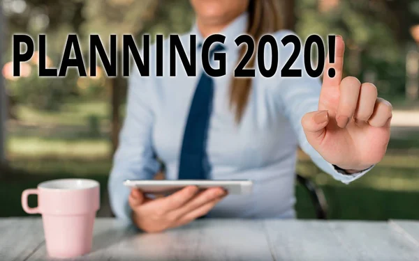 Conceptual hand writing showing Planning 2020. Business photo text process of making plans for something next year Female business person sitting by table and holding mobile phone. — Φωτογραφία Αρχείου