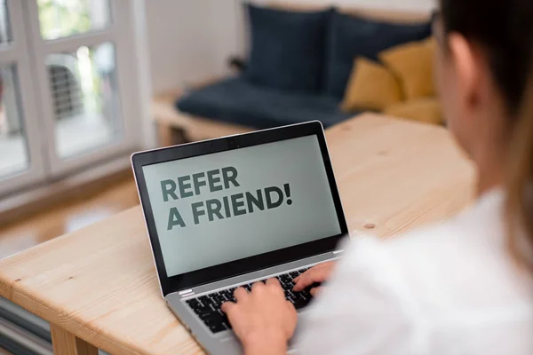 Conceptual hand writing showing Refer A Friend. Business photo text direct someone to another or send him something like gift woman with laptop smartphone and office supplies technology. — Stock Photo, Image