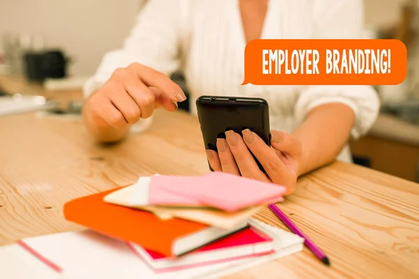 Word writing text Employer Branding. Business concept for promoting company employer choice to desired target group woman using smartphone office supplies technological devices inside home.