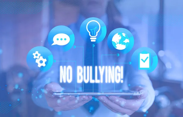 Writing note showing No Bullying. Business photo showcasing stop aggressive behavior among children power imbalance Female human wear formal work suit presenting smart device.