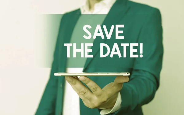 Handwriting text Save The Date. Concept meaning remember not schedule anything else on this day Man in the blue suite and white shirt holds mobile phone in the hand.