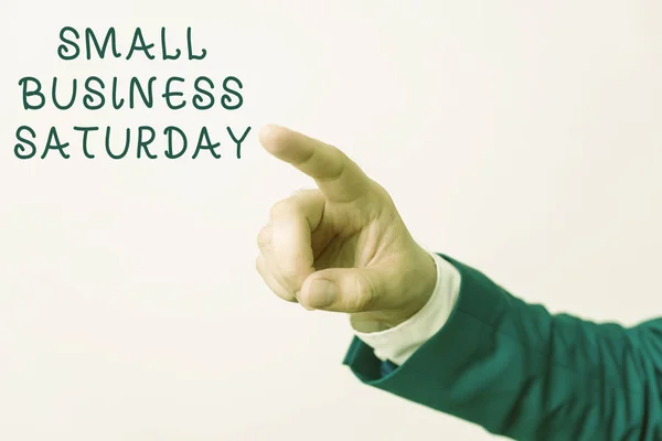 Word writing text Small Business Saturday. Business concept for American shopping holiday held during the Saturday Isolated hand pointing with finger. Business concept pointing finger.