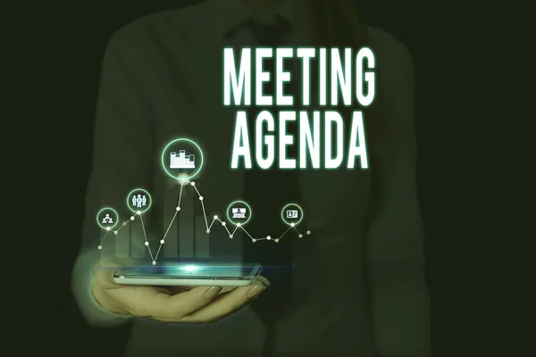 Text sign showing Meeting Agenda. Conceptual photo items that participants hope to accomplish at a meeting Woman wear formal work suit presenting presentation using smart device.