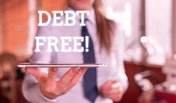 Word writing text Debt Free. Business concept for does not owning any money or things to any individual or companies Blurred woman in the background pointing with finger in empty space.