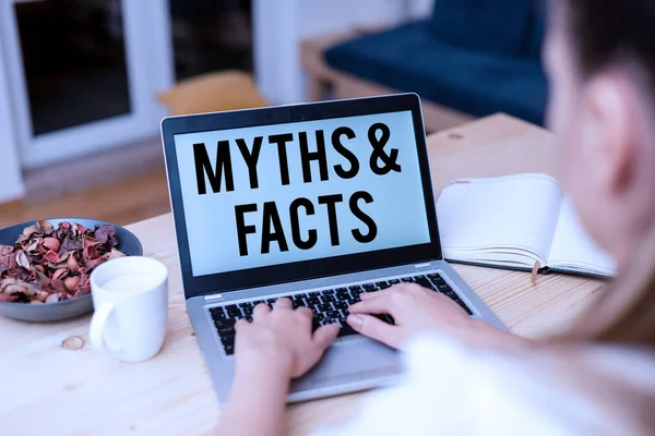 Handwriting text Myths And Facts. Concept meaning usually traditional story of ostensibly historical events woman laptop computer smartphone mug office supplies technological devices. — Stock Photo, Image