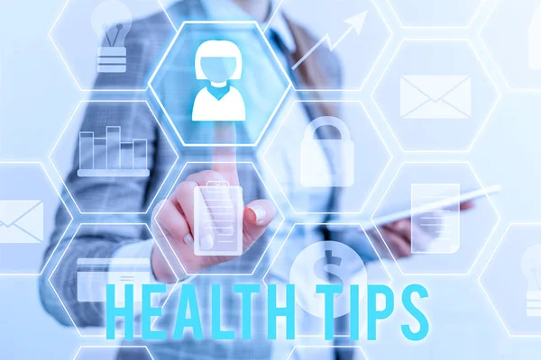 Writing note showing Health Tips. Business photo showcasing advice or information given to be helpful in being healthy Lady front presenting hand blue glow futuristic modern technology. — Stock Photo, Image