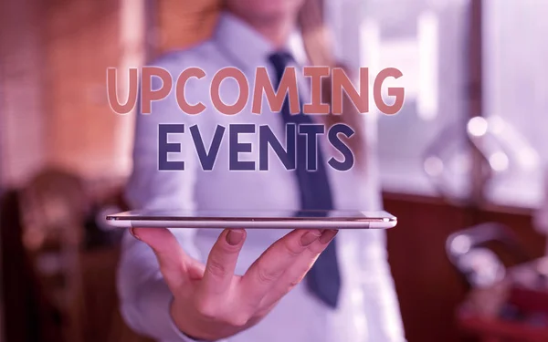 Writing note showing Upcoming Events. Business photo showcasing the approaching planned public or social occasions Blurred woman in the background pointing with finger in empty space. — Stock Photo, Image