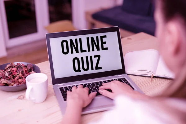 Handwriting text Online Quiz. Concept meaning game or a mind sport that are published on the Internet woman laptop computer smartphone mug office supplies technological devices.