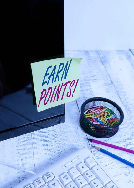 Text sign showing Earn Points. Conceptual photo collecting scores in order qualify to win big prize Note paper taped to black computer screen near keyboard and stationary.