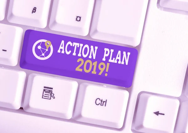 Conceptual hand writing showing Action Plan 2019. Business photo showcasing proposed strategy or course of actions for current year White pc keyboard with note paper above the white background.