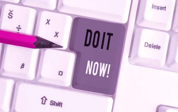 Handwriting text Do It Now. Concept meaning not hesitate and start working or doing stuff right away White pc keyboard with empty note paper above white background key copy space.