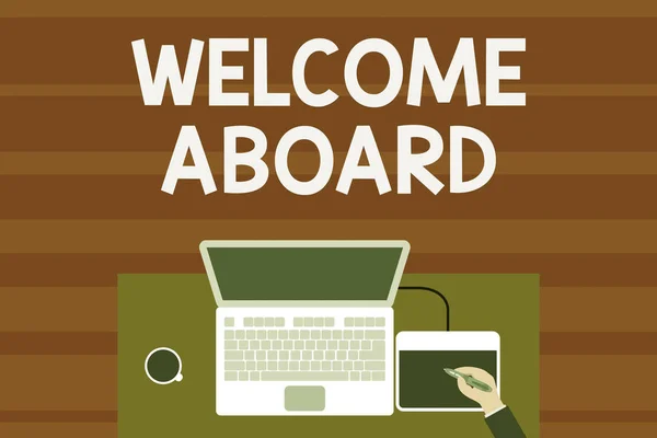 Text sign showing Welcome Aboard. Conceptual photo Expression of greetings to a demonstrating whose arrived is desired Upper view laptop wooden desk worker drawing tablet coffee cup office.
