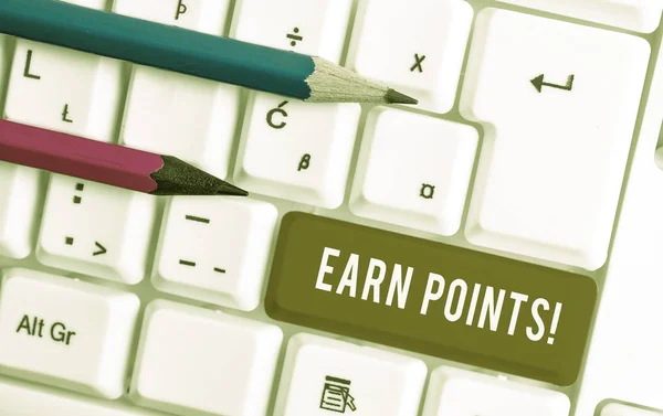 Conceptual hand writing showing Earn Points. Business photo text collecting scores in order qualify to win big prize White pc keyboard with note paper above the white background.