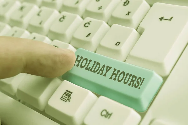 Conceptual hand writing showing Holiday Hours. Business photo showcasing Overtime work on for employees under flexible work schedules White pc keyboard with note paper above the white background.