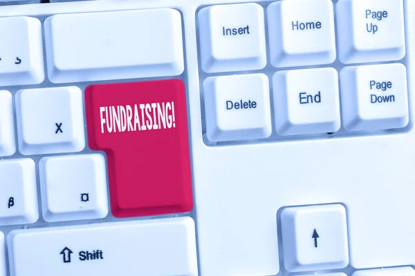 Word writing text Fundraising. Business concept for seeking to generate financial support for charity or cause White pc keyboard with empty note paper above white background key copy space. — Stock Photo, Image