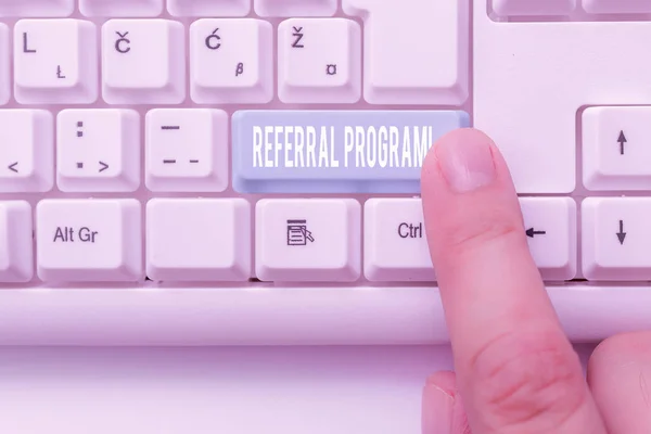 Writing note showing Referral Program. Business photo showcasing internal recruitment method employed by organizations White pc keyboard with note paper above the white background.