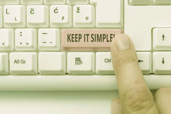 Text sign showing Keep It Simple. Conceptual photo ask something easy understand not go into too much detail White pc keyboard with empty note paper above white background key copy space.