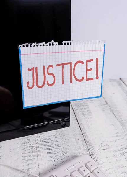 Text sign showing Justice. Conceptual photo impartial adjustment of conflicting claims or assignments Notation paper taped to black computer monitor screen near white keyboard. — Stock Photo, Image