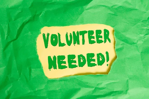 Writing note showing Volunteer Needed. Business photo showcasing need work for organization without being paid Green crumpled colored paper sheet torn colorful background.
