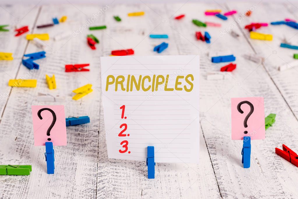 Text sign showing Principles. Conceptual photo fundamental truth that serves as the base for a system of belief Scribbled and crumbling sheet with paper clips placed on the wooden table.