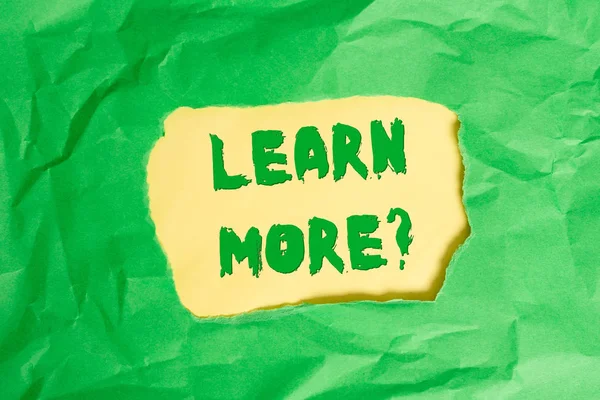 Writing note showing Learn More question. Business photo showcasing gain knowledge or skill studying practicing Green crumpled colored paper sheet torn colorful background.