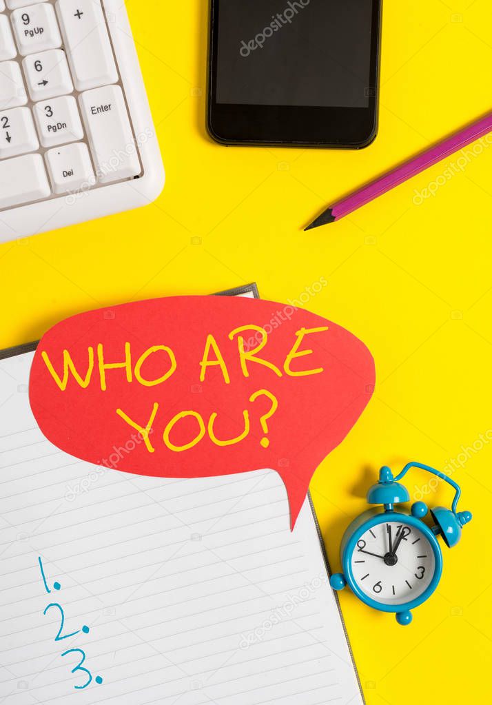 Text sign showing Who Are You question. Conceptual photo asking about demonstrating identity or demonstratingal information Empty red bubble paper on the table with pc keyboard.