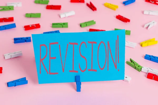 Writing note showing Revision. Business photo showcasing action of revising over someone like auditing or accounting Colored clothespin papers empty reminder pink floor office pin. — Stock Photo, Image