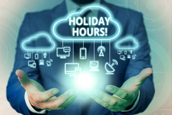 Text sign showing Holiday Hours. Conceptual photo Overtime work on for employees under flexible work schedules Male human wear formal work suit presenting presentation using smart device.