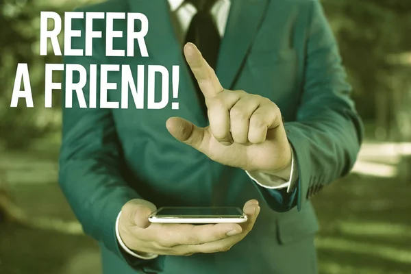 Text sign showing Refer A Friend. Conceptual photo direct someone to another or send him something like gift Man with opened hands stands in suite. Concept with copy space and man. — Stock Photo, Image