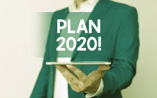 Handwriting text Plan 2020. Concept meaning detailed proposal doing achieving something next year Man in the blue suite and white shirt holds mobile phone in the hand. — Stock Photo, Image