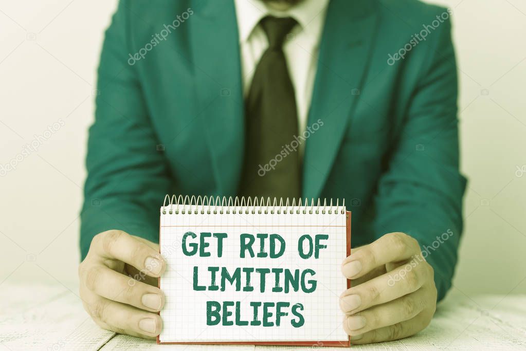 Word writing text Get Rid Of Limiting Beliefs. Business concept for remove negative beliefs and think positively Man holds empty paper with copy space in front of him Space.