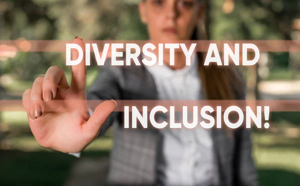 Word writing text Diversity And Inclusion. Business concept for range huanalysis difference includes race ethnicity gender Business woman in the nature pointing with the finger into empty space.