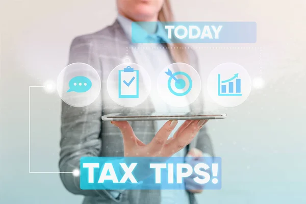 Writing note showing Tax Tips. Business photo showcasing compulsory contribution to state revenue levied by government Female human wear formal work suit presenting smart device. — Stock Photo, Image
