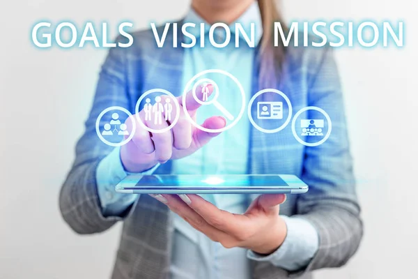Conceptual hand writing showing Goals Vision Mission. Business photo text practical planning process used to help community group Lady front presenting hand blue glow futuristic modern technology.