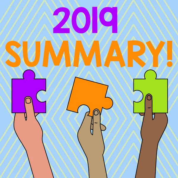 Text sign showing 2019 Summary. Conceptual photo summarizing past year events main actions or good shows Three Colored Empty Jigsaw Puzzle Pieces Held in Different People Hands.