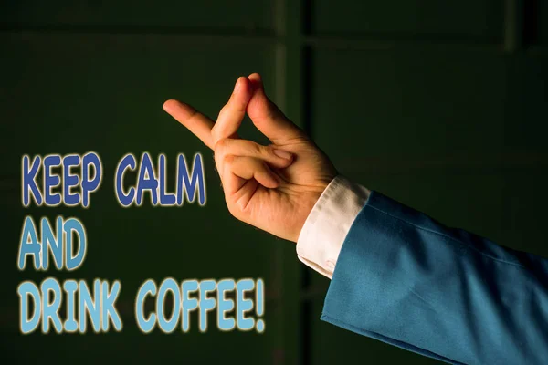 Text sign showing Keep Calm And Drink Coffee. Conceptual photo encourage demonstrating to enjoy caffeine drink and relax Isolated hand pointing with finger. Business concept pointing finger. — Stock Photo, Image