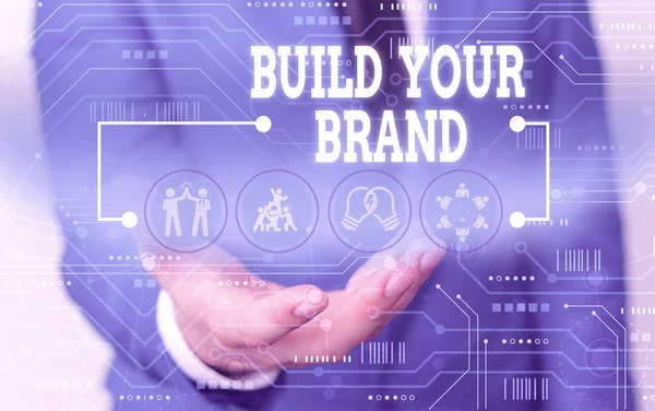 Handwriting text writing Build Your Brand. Concept meaning enhancing brand equity using advertising campaigns Male human wear formal work suit presenting presentation using smart device.
