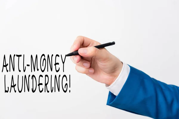 Text sign showing Anti Money Laundering. Conceptual photo regulations stop generating income through illegal actions Isolated hand above white background. Pointing pen in the hand on white background.