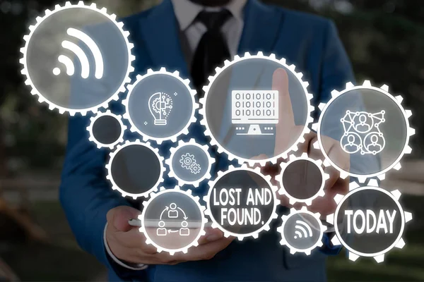 Text sign showing Lost And Found. Conceptual photo a place where lost items are stored until they reclaimed Male human wear formal work suit presenting presentation using smart device. — Stock Photo, Image