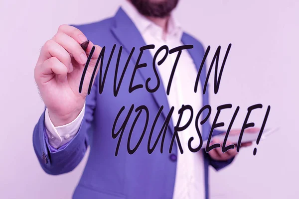 Text sign showing Invest In Yourself. Conceptual photo nvesting in a coach or a training to learn new things Businessman in blue suite and white shirt pointing with finger in empty space. — 图库照片